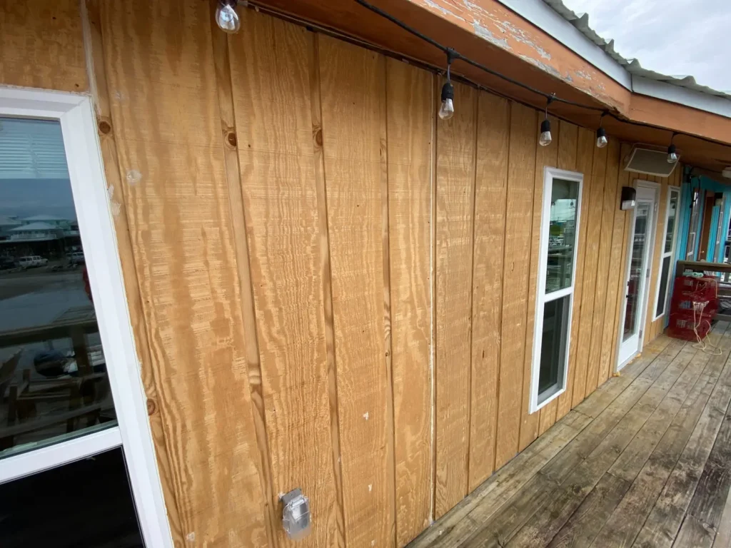New wood siding, windows, and doors along The Alibi's exterior deck.