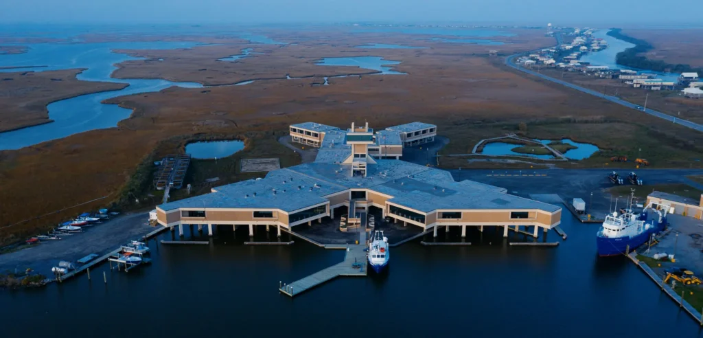 Aerial view of LUMCON's W.J. DeFelice Marine Center, docks, research vessels, marsh, and Cocodrie.